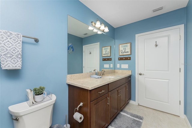 bathroom with tile patterned flooring, vanity, and toilet