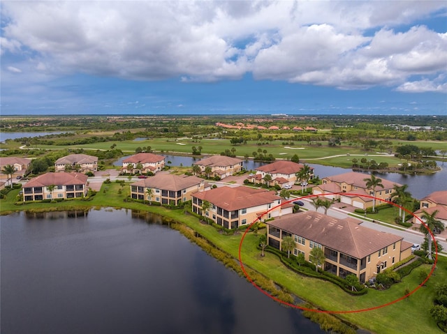 birds eye view of property with a water view