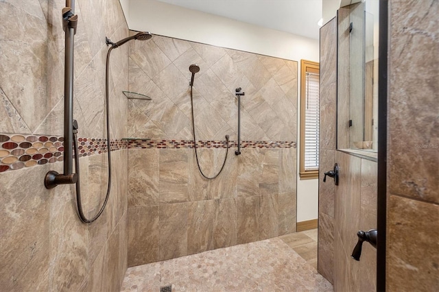 bathroom with tiled shower