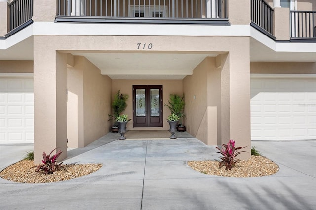 710 Albee Rd W, Nokomis, FL 34275 - entrance to property featuring french doors, stucco siding, a garage, and a balcony
