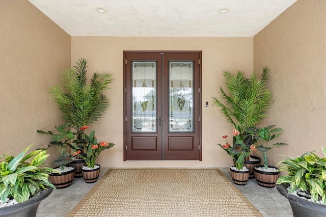 710 Albee Rd W, Nokomis, FL 34275 - view of exterior entry with french doors and stucco siding