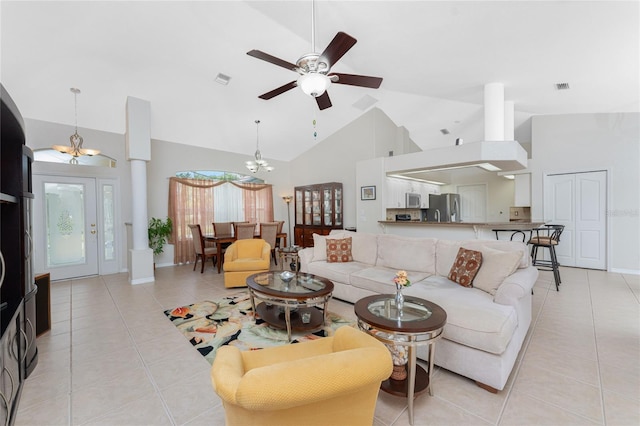 living room featuring ceiling fan with notable chandelier, light tile patterned floors, and high vaulted ceiling