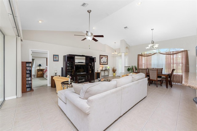 living room with light tile patterned floors, ceiling fan with notable chandelier, and lofted ceiling