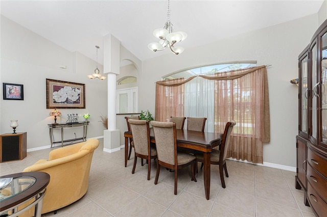 dining room featuring light tile patterned flooring, vaulted ceiling, and an inviting chandelier