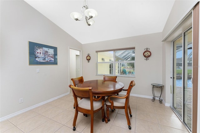 dining area with light tile patterned flooring, lofted ceiling, a wealth of natural light, and an inviting chandelier