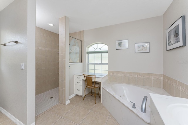 bathroom featuring tile patterned floors, vanity, and shower with separate bathtub