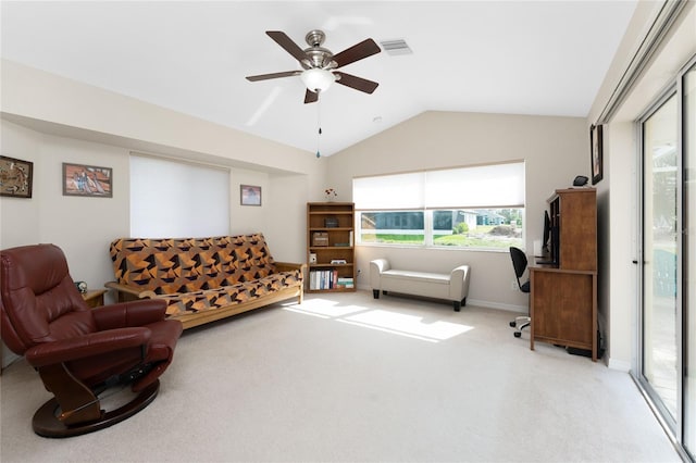 carpeted living room featuring ceiling fan and lofted ceiling