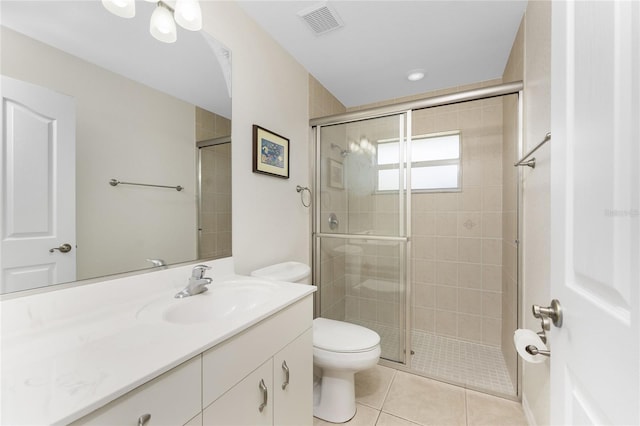 bathroom featuring tile patterned flooring, vanity, an enclosed shower, and toilet