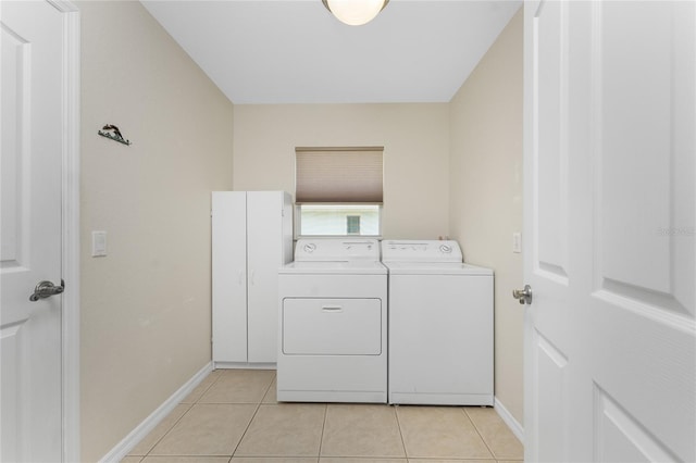 washroom featuring separate washer and dryer and light tile patterned floors