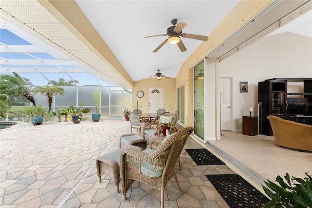 view of patio featuring glass enclosure and ceiling fan