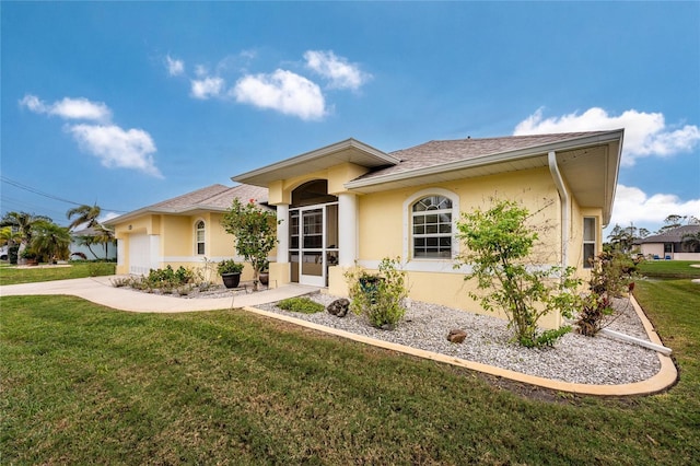 view of front of home with a garage and a front lawn