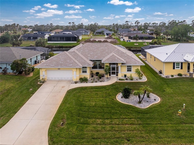 view of front of property featuring a garage and a front lawn