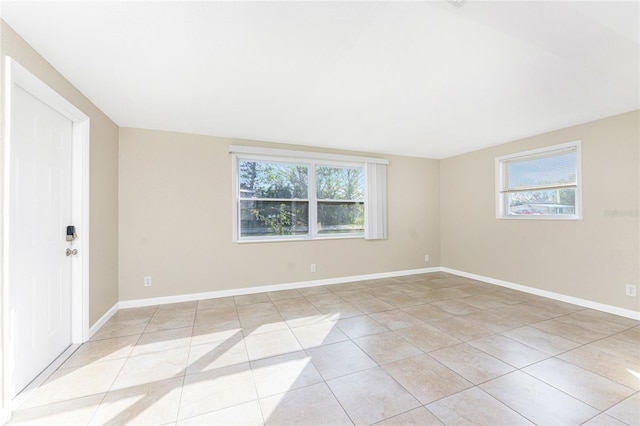 tiled empty room with a wealth of natural light