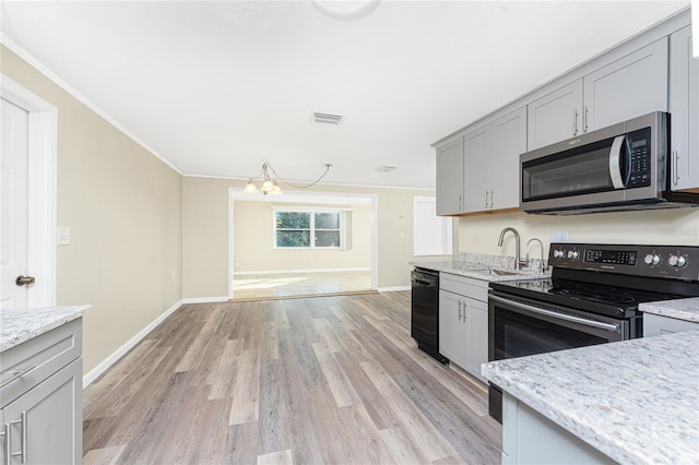 kitchen featuring sink, gray cabinets, black appliances, and ornamental molding