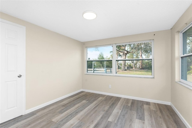 unfurnished room with light hardwood / wood-style floors