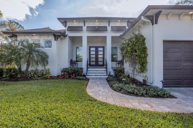 property entrance featuring covered porch, a yard, and a garage