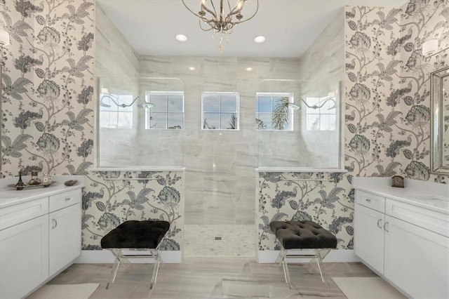 bathroom featuring vanity, a tile shower, and a chandelier