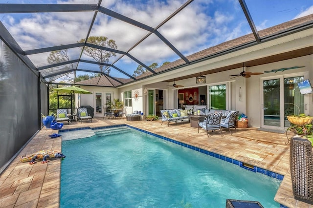 view of pool featuring french doors, an outdoor living space, glass enclosure, and a patio area