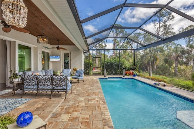 view of swimming pool with ceiling fan, a patio area, a lanai, and an outdoor hangout area