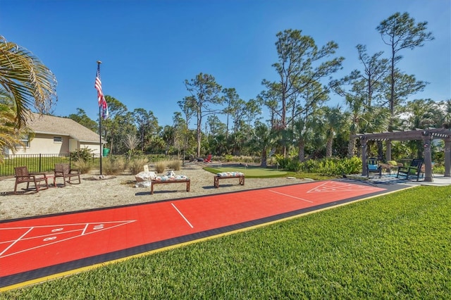 view of property's community featuring a lawn and a pergola