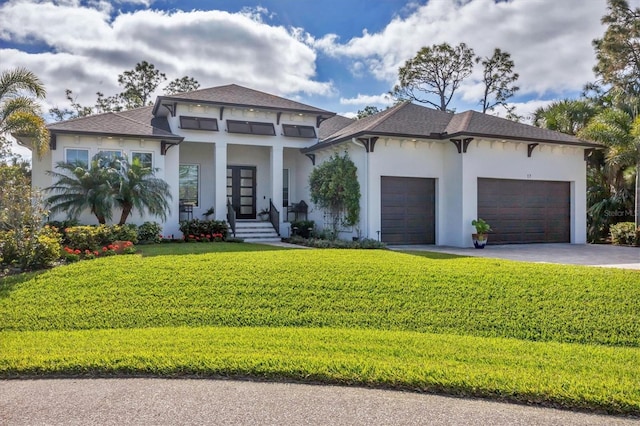 view of front facade with a front yard and a garage