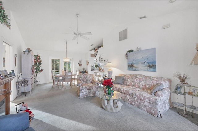 carpeted living room with french doors, ceiling fan, and lofted ceiling