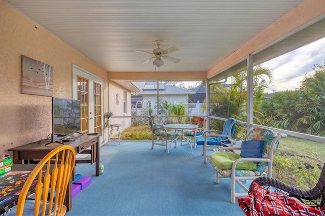 sunroom / solarium with ceiling fan and french doors