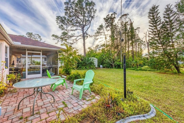 view of yard featuring a sunroom and a patio