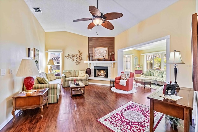 living room featuring a large fireplace, ceiling fan, hardwood / wood-style floors, and lofted ceiling