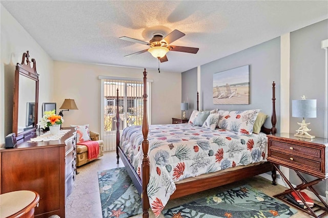 bedroom with ceiling fan and a textured ceiling