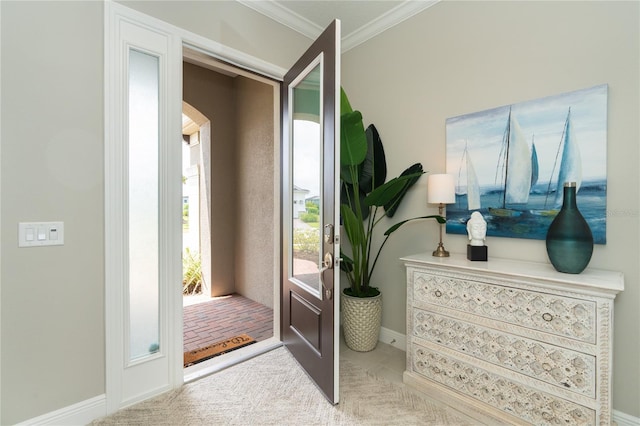 entrance foyer featuring light carpet and ornamental molding