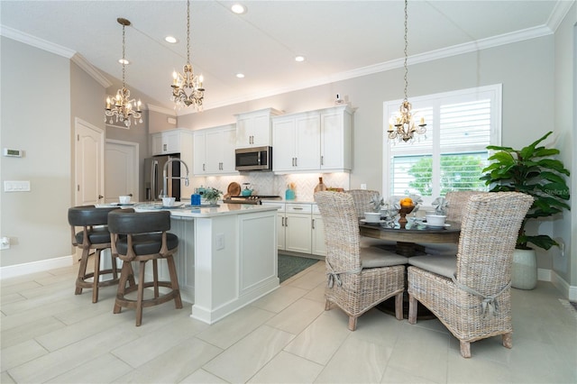 kitchen featuring white cabinets, a center island with sink, and stainless steel appliances