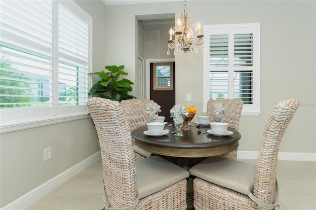 dining area featuring light tile patterned floors and an inviting chandelier