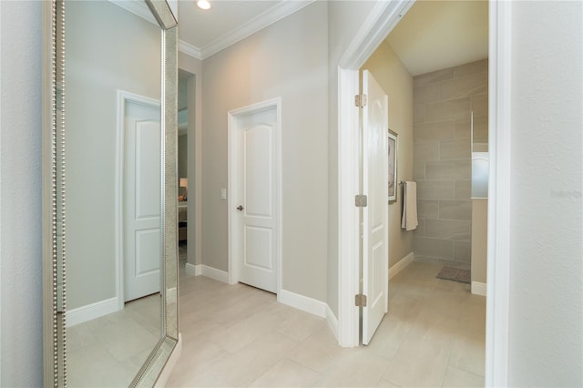 hall featuring light tile patterned floors and ornamental molding