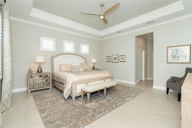 bedroom with a tray ceiling, ceiling fan, and ornamental molding