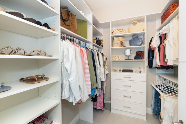 spacious closet with light tile patterned floors