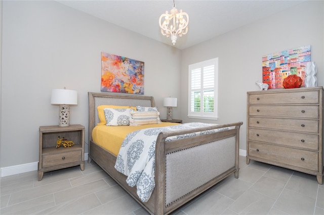 tiled bedroom featuring a chandelier