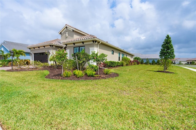 view of side of property featuring a yard and a garage