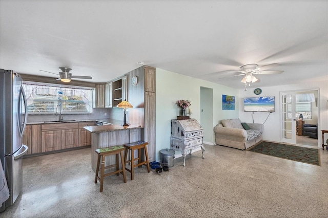 living room featuring ceiling fan and sink