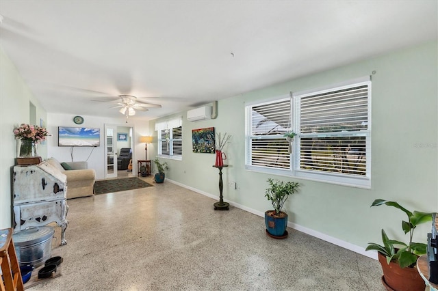 living room featuring a wall mounted AC and ceiling fan