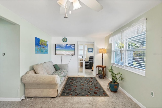 living room with ceiling fan and carpet floors