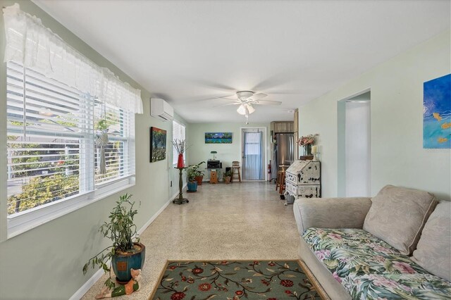 living room with a wall mounted AC and ceiling fan