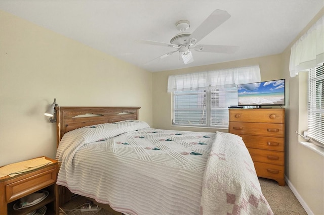 bedroom featuring multiple windows, carpet floors, and ceiling fan