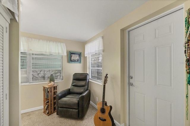 sitting room featuring light colored carpet