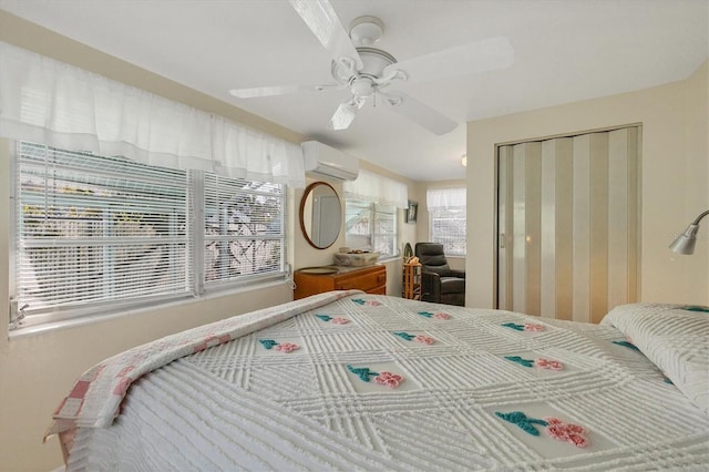 bedroom with a wall mounted AC, a closet, and ceiling fan