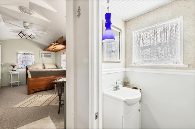 bathroom featuring ceiling fan, lofted ceiling, and vanity