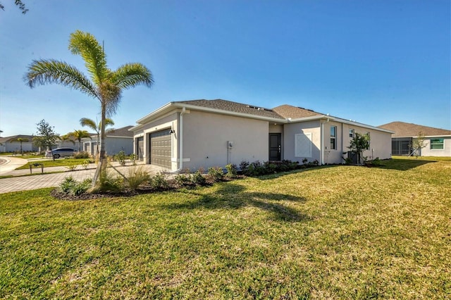 ranch-style home with driveway, a front lawn, an attached garage, and stucco siding