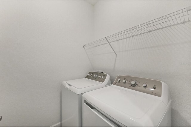 washroom with laundry area and separate washer and dryer