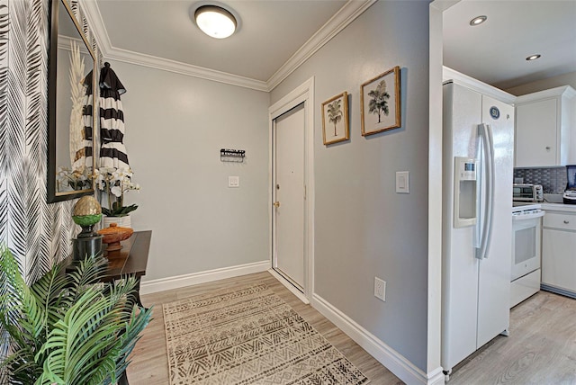 interior space with crown molding and light hardwood / wood-style flooring