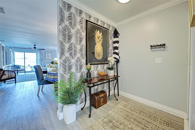 hallway featuring ornamental molding and light hardwood / wood-style flooring